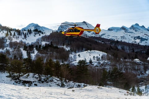Emergency helicopter in winter mountain environment