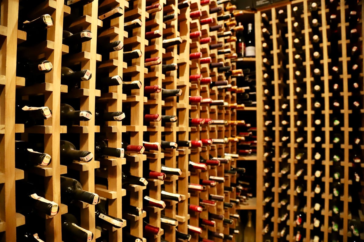 Wine cellar with bottles in wooden cabinet, luxury wine collection