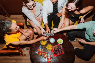 Friends cheering with shot glasses in vibrant bar setting