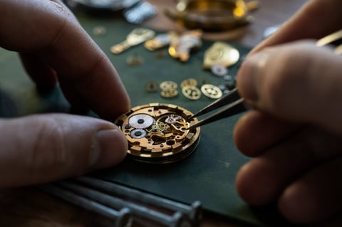 Watchmaker repairing a mechanical watch