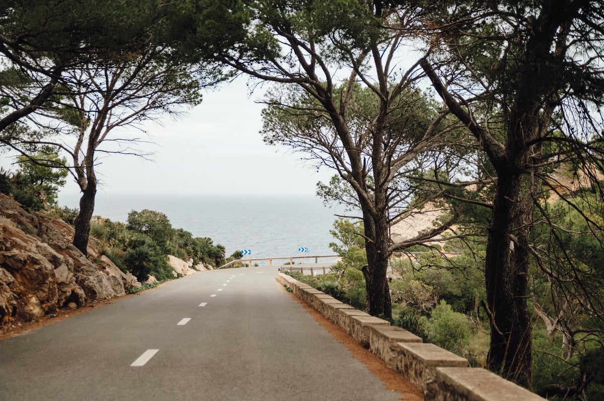 Scenic coastal road winding toward the sea