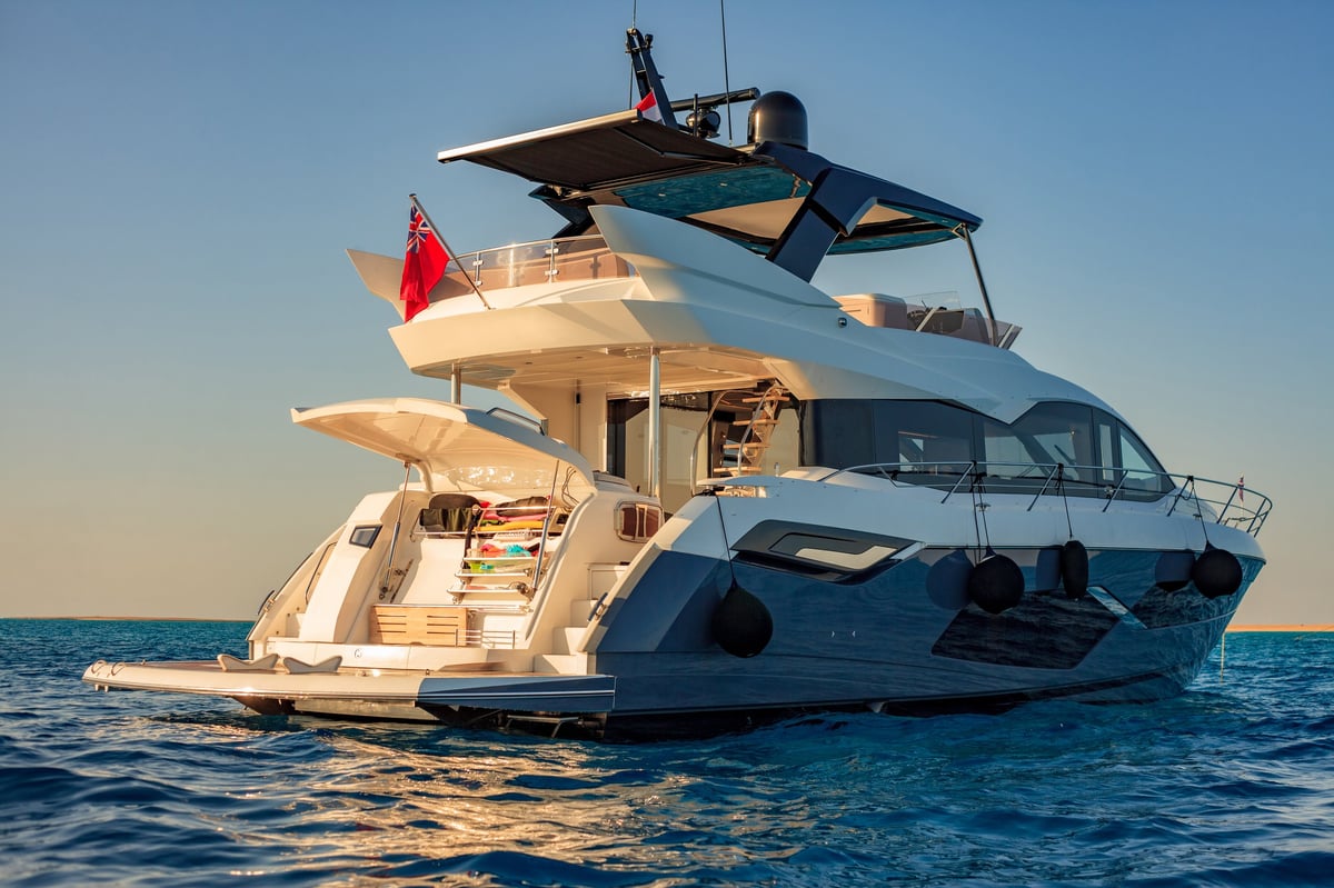 A large white luxury boat is floating in the ocean