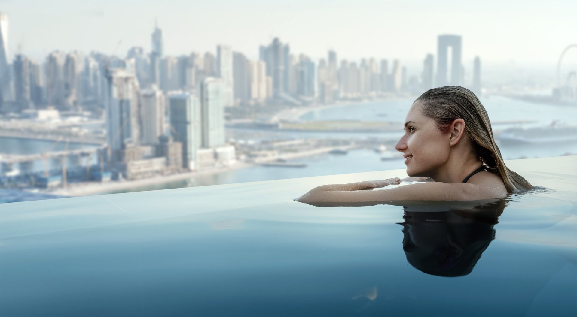 Luxury Dubai skyline panorama from rooftop infinity pool