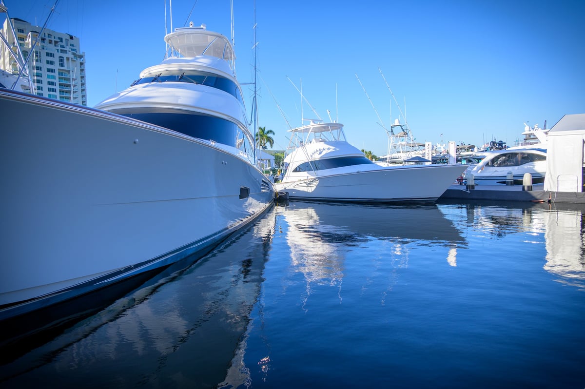 Yachts reflecting on deep blue water at a marina