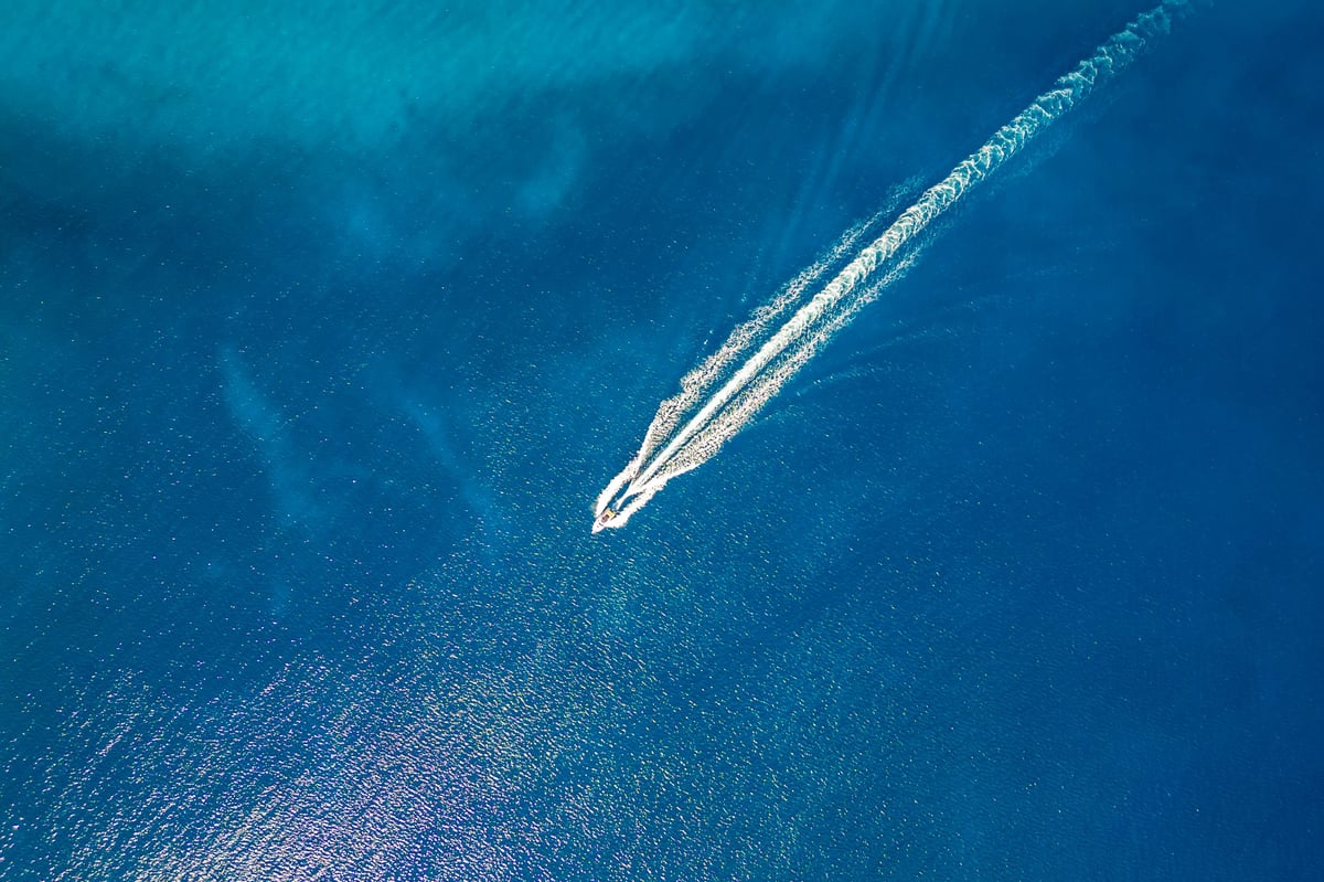powerboat wake through blue water