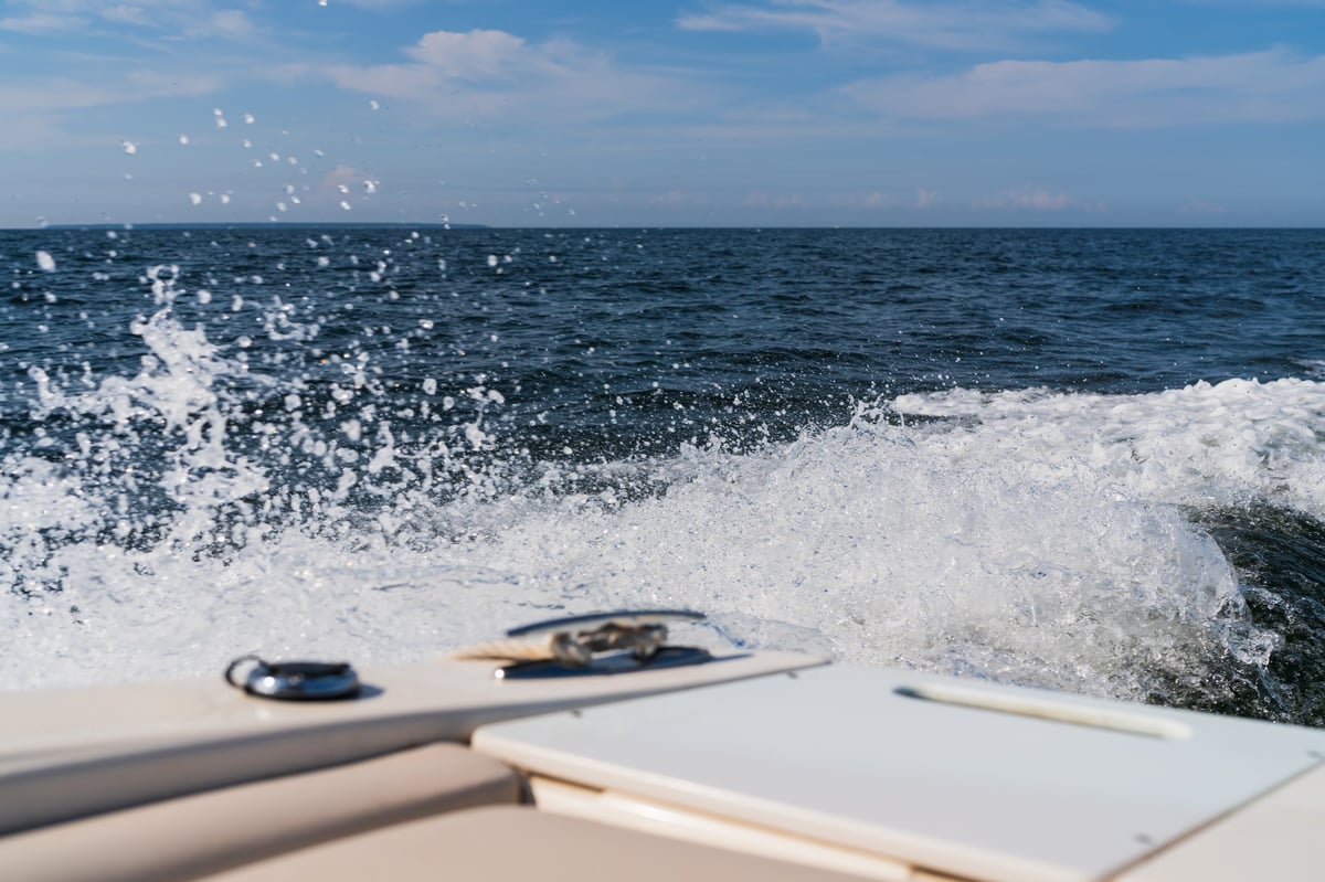White water splashes and foam from a fast motorboat