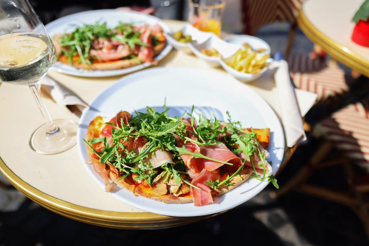 Pizza, olives and aperitif on terrace table with European street food and travel lifestyle
