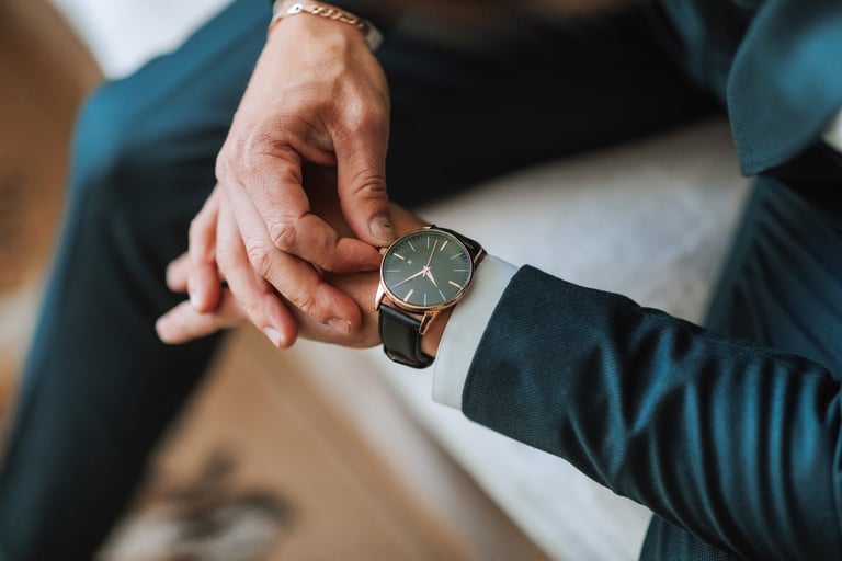 A man wearing a luxury watch with a suit