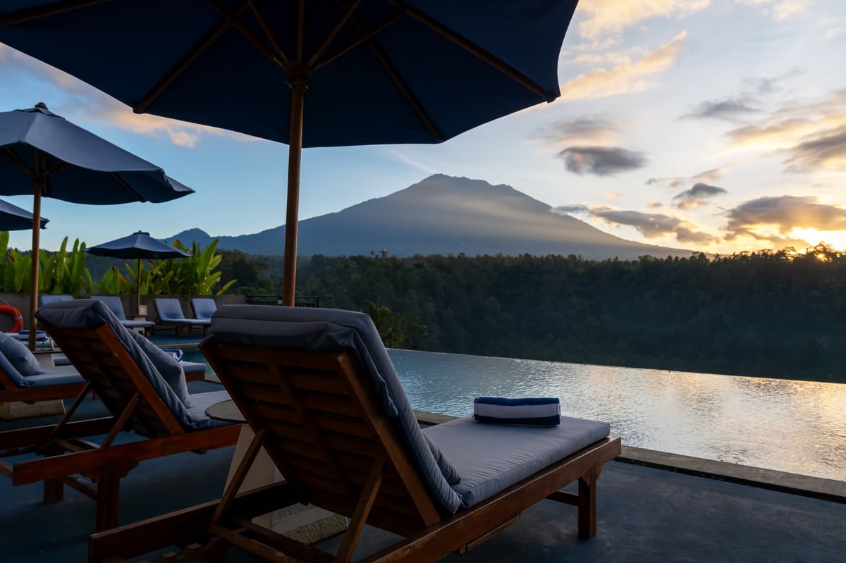View of Mt. Agung and infinity pool in a resort in Karangasem, Bali, Indonesia