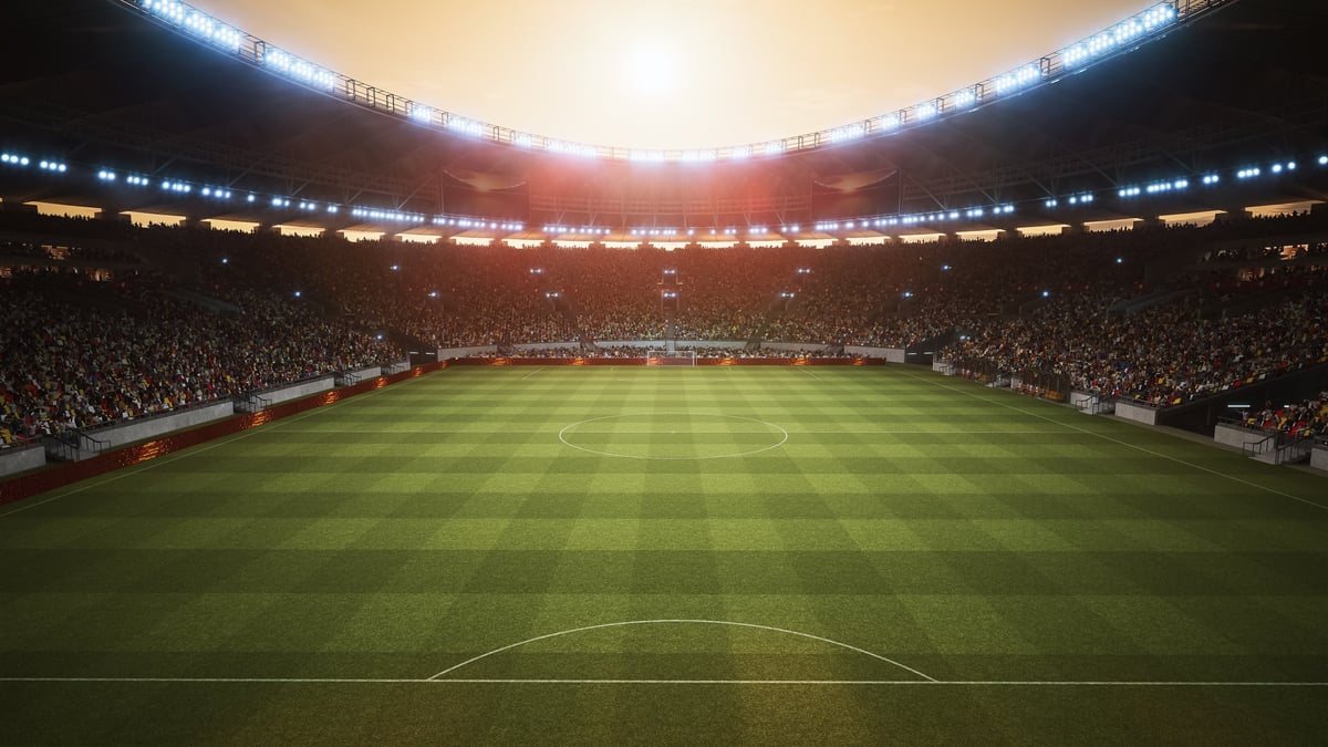 Soccer Stadium Hosts a Championship Final at Sunset With Fans Celebrating in Packed Stands