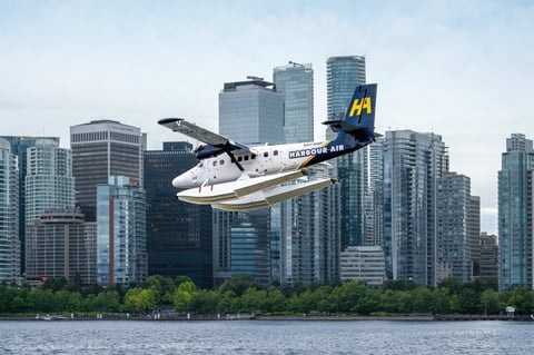 Seaplane landing on Vancouver Harbour with city skyline in the background