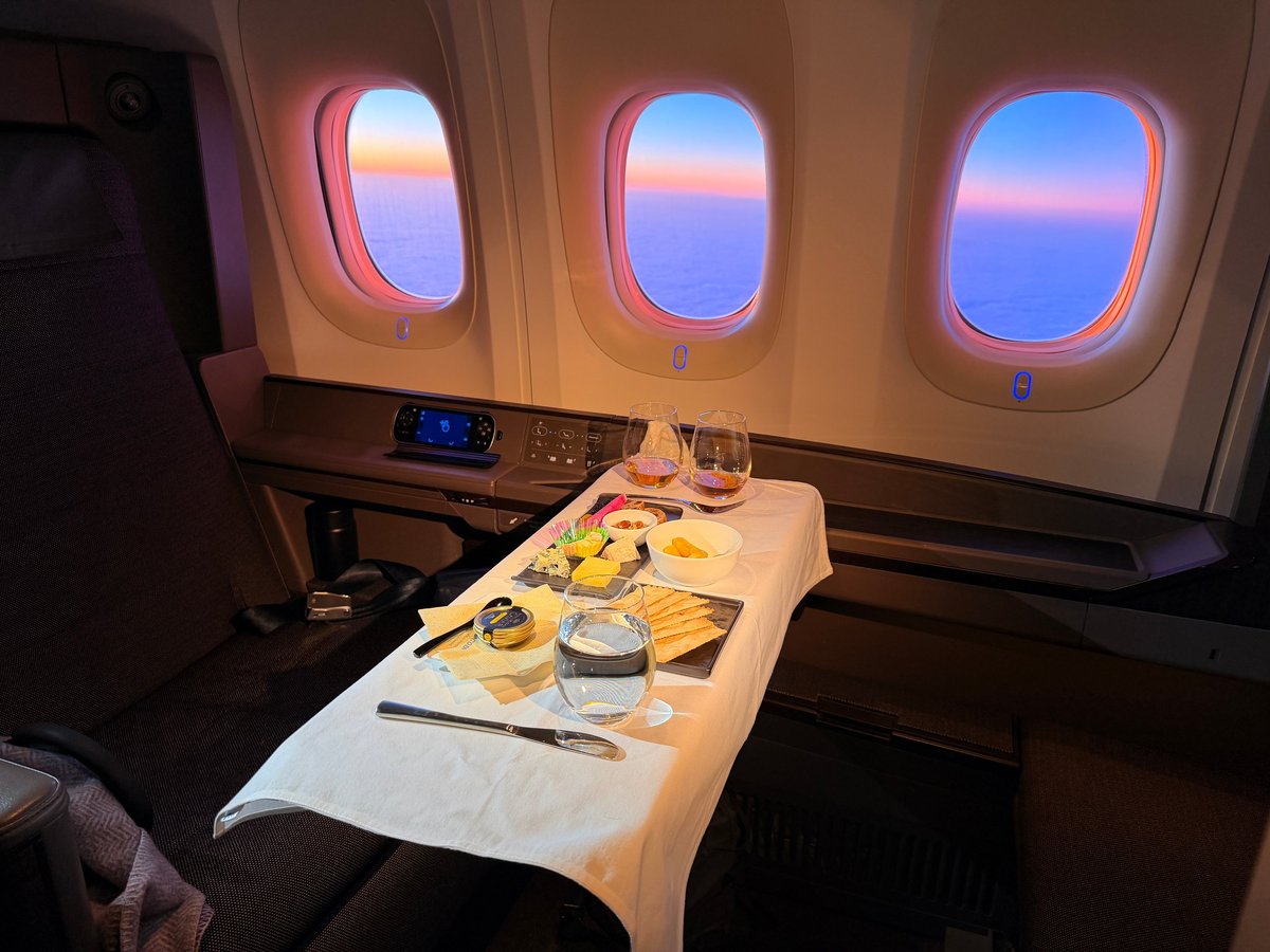 First class airplane suite with premium dining during an international flight