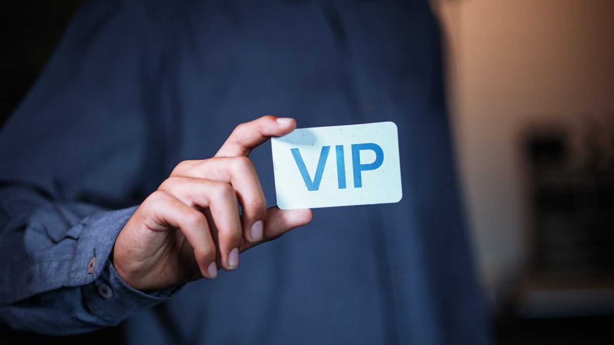 Businessman holding VIP card representing premium membership and exclusive access