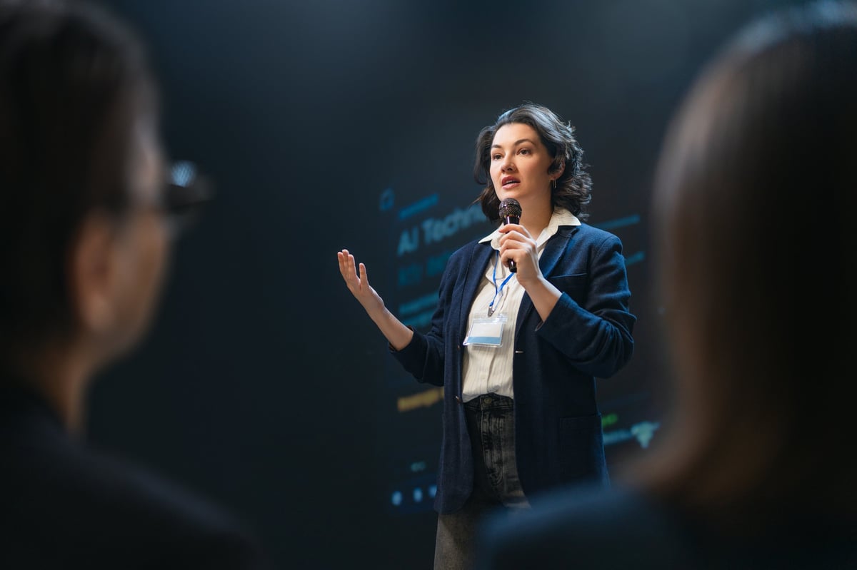 Businesswoman addresses audience at a modern conference