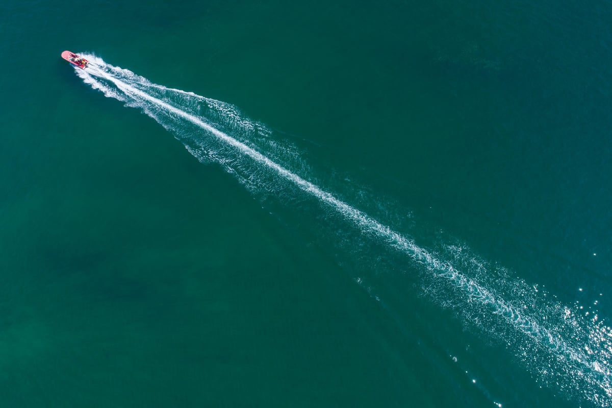 Aerial view of a fast boat on turquoise sea The Concept of adventure