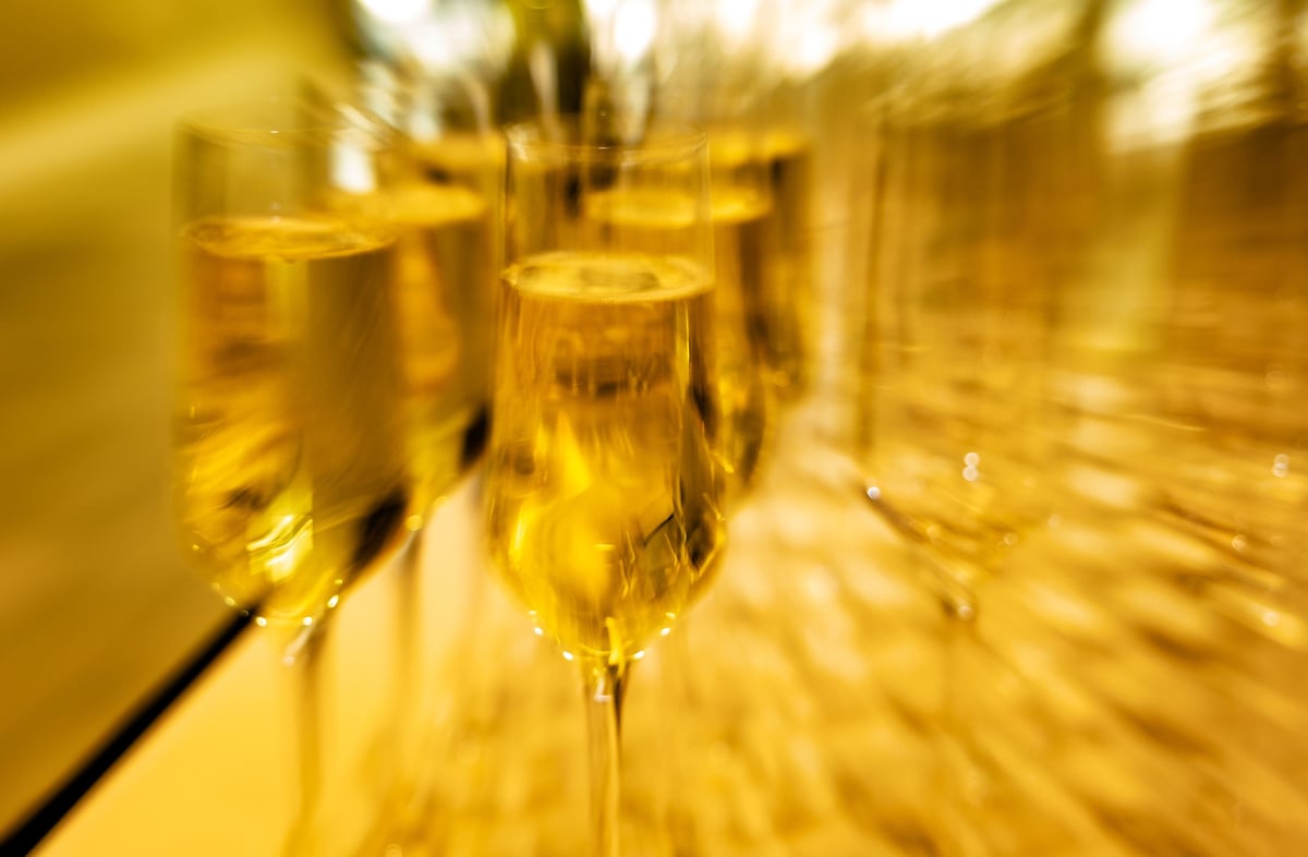 Guests enjoy exclusive cava in beautifully arranged glasses at a lavish gala event held in an upscale venue