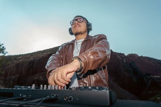 DJ playing electronic music at outdoor event