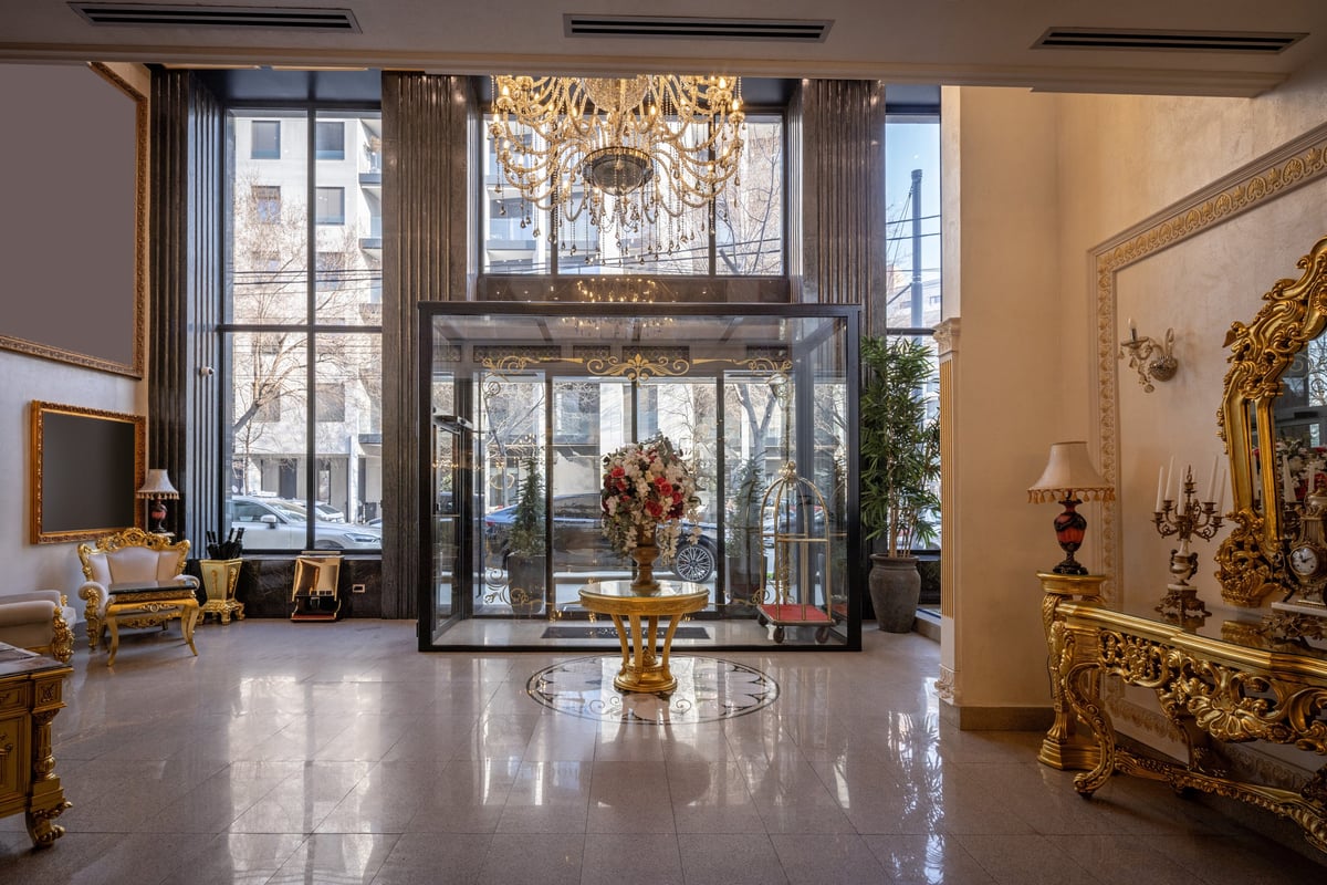 Luxury hotel lobby interior with gilded furniture and crystal chandelier in elegant classic style