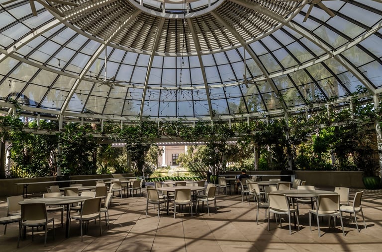 Rose Hills Foundation Garden Court at the Huntington Library, botanical garden pavilion with glass dome greenhouse, tables chairs, tropical plants, natural light architecture