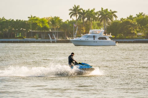 Man riding jet ski at golden hour
