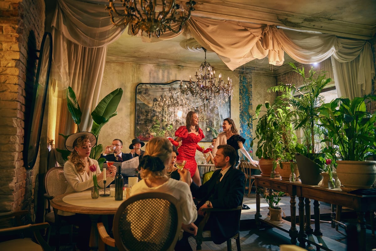 Retro party scene with women dancing in elegant restaurant interior