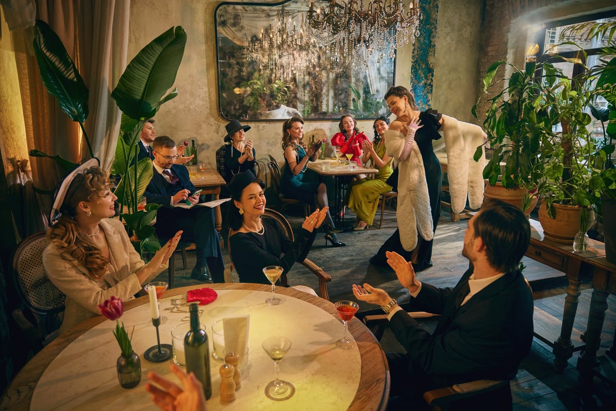 Stylish audience applauding singer during retro dinner show