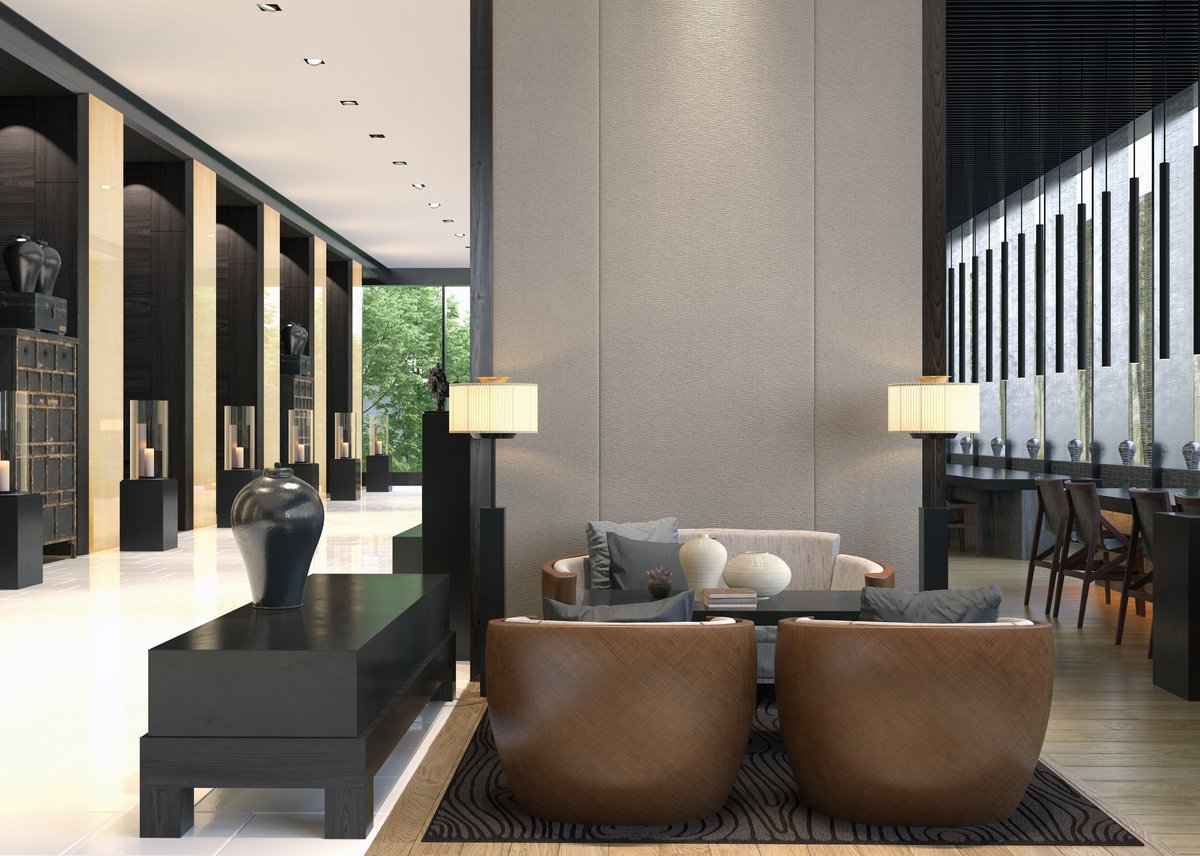 A modern luxury lounge interior featuring a seating area with brown armchairs
