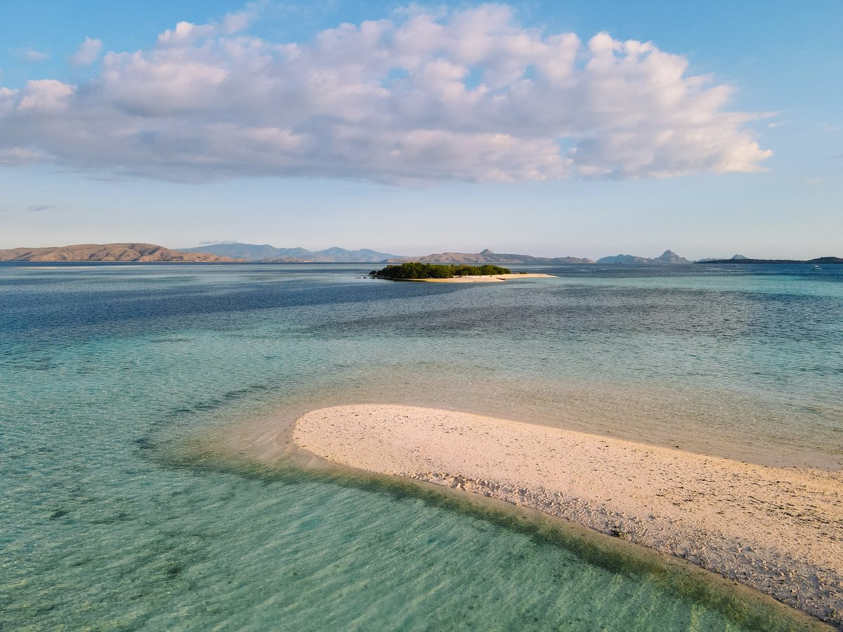 Crescent-shaped sandbar with turquoise lagoons in Komodo National Park