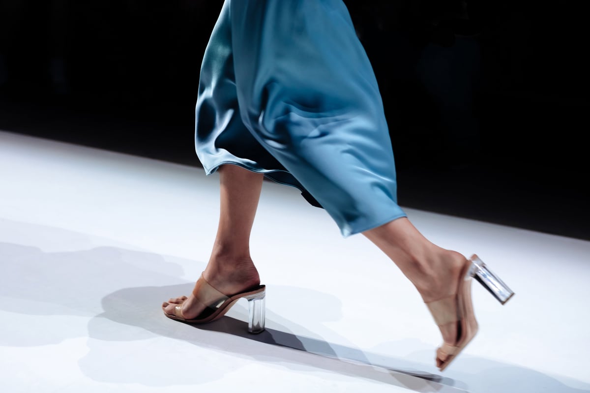 Fashion details of classy silk blue skirt, jacket and beige high heels