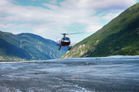 Helicopter tour flying over rugged mountain terrain and glacial moraine
