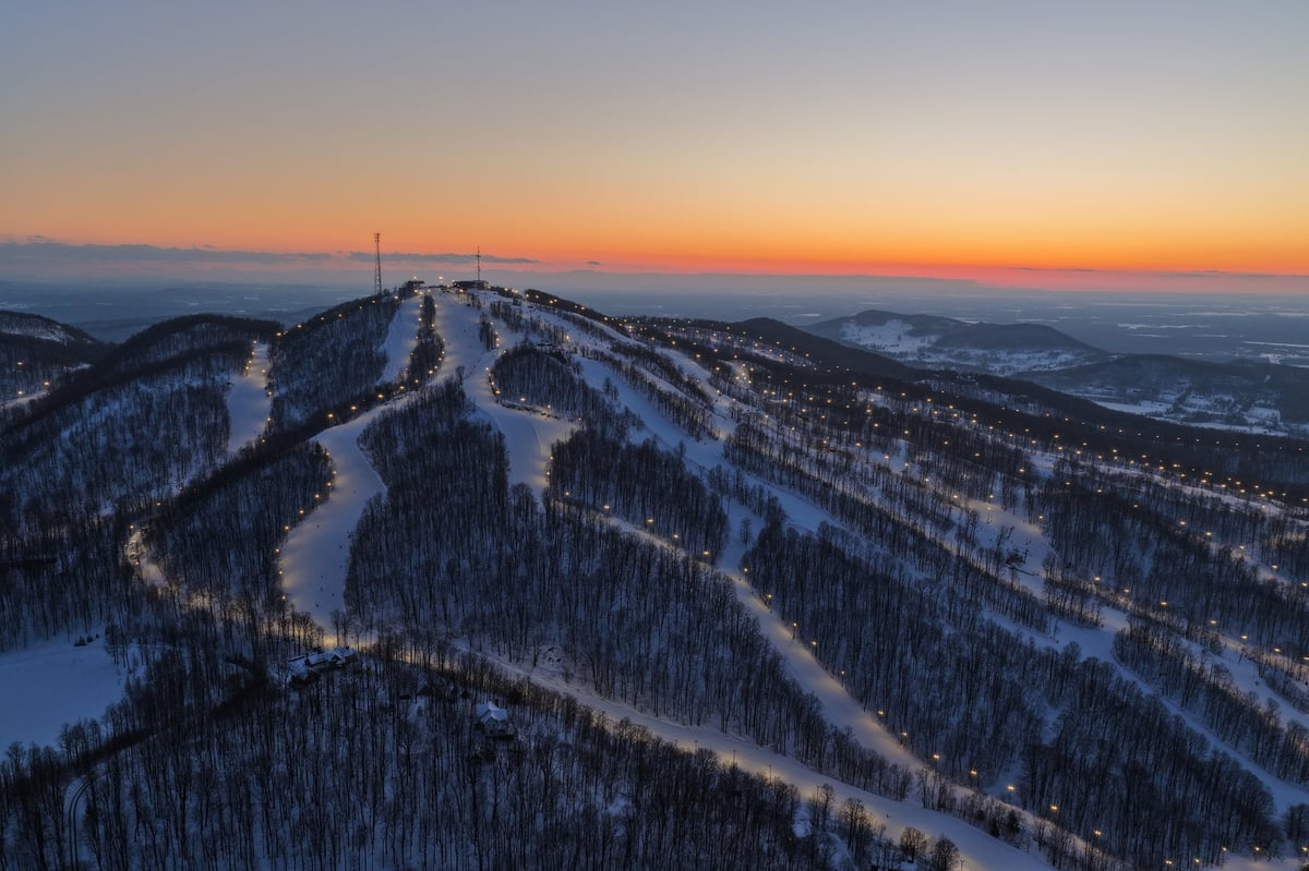 Alpine ski resort slopes at dusk in winter