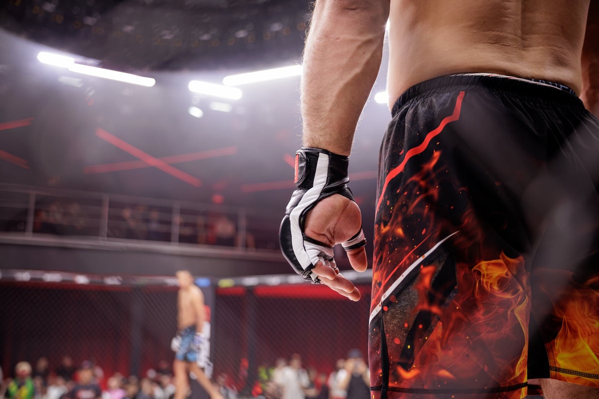 MMA fighter stands ready in the octagon, showcasing determination and focus
