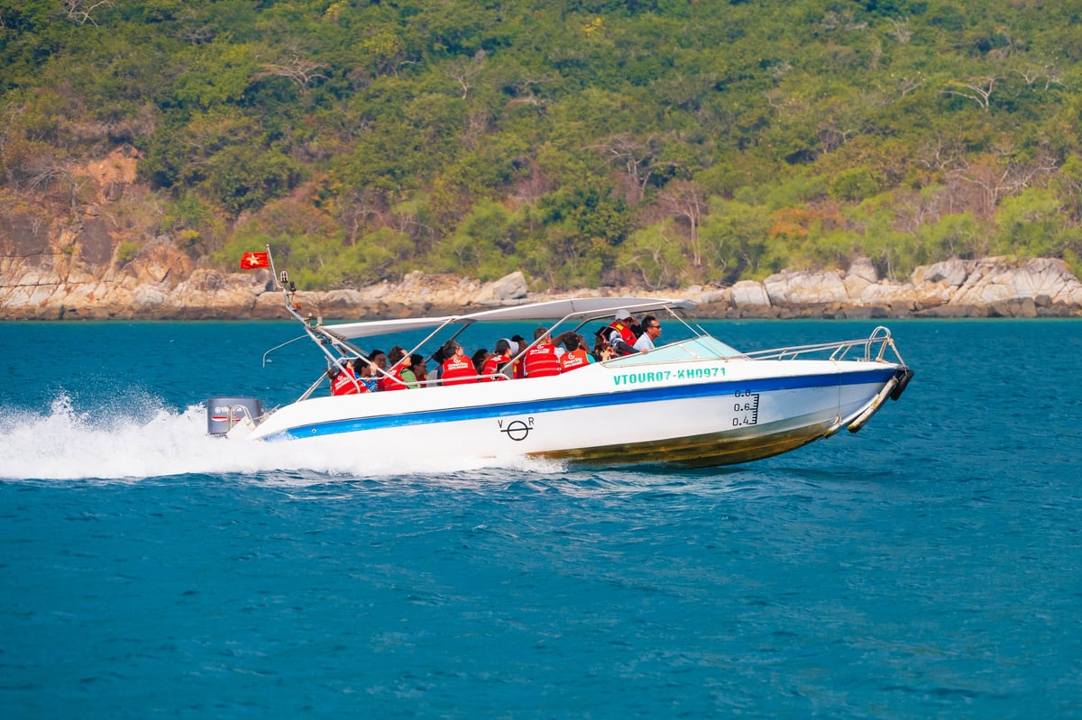High-speed motorboat white tourist speedboat with tourists sails through the sea