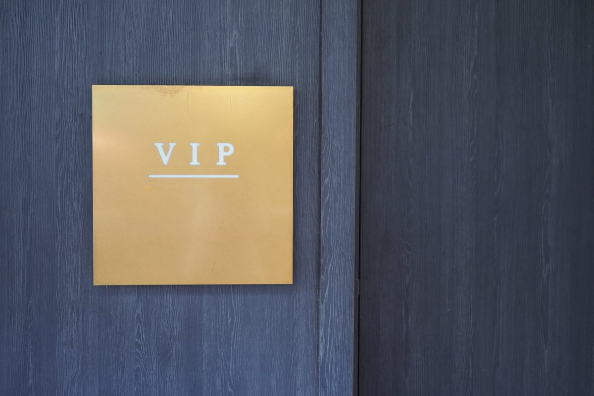 A gold sign labeled VIP is mounted on a modern wall