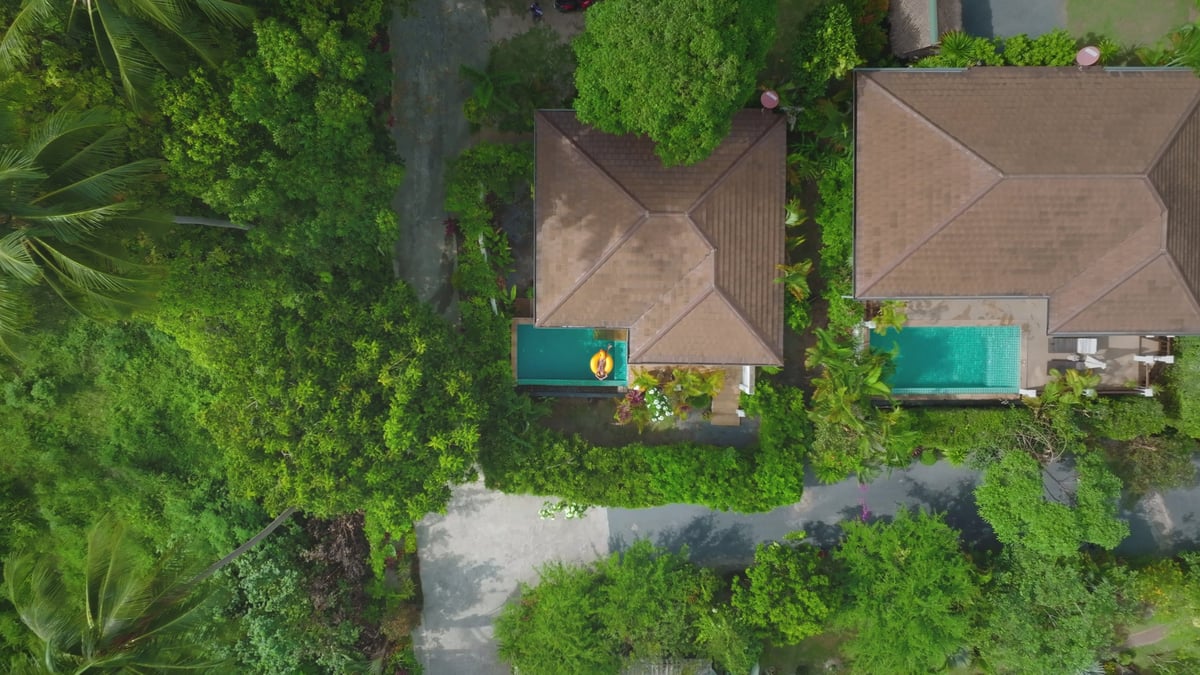 Aerial view two private pool villas in tropical jungle forest resort