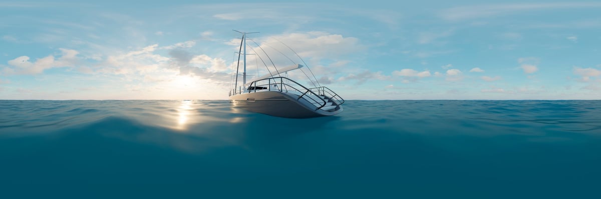 A sleek white sailboat anchored in tranquil turquoise ocean waters
