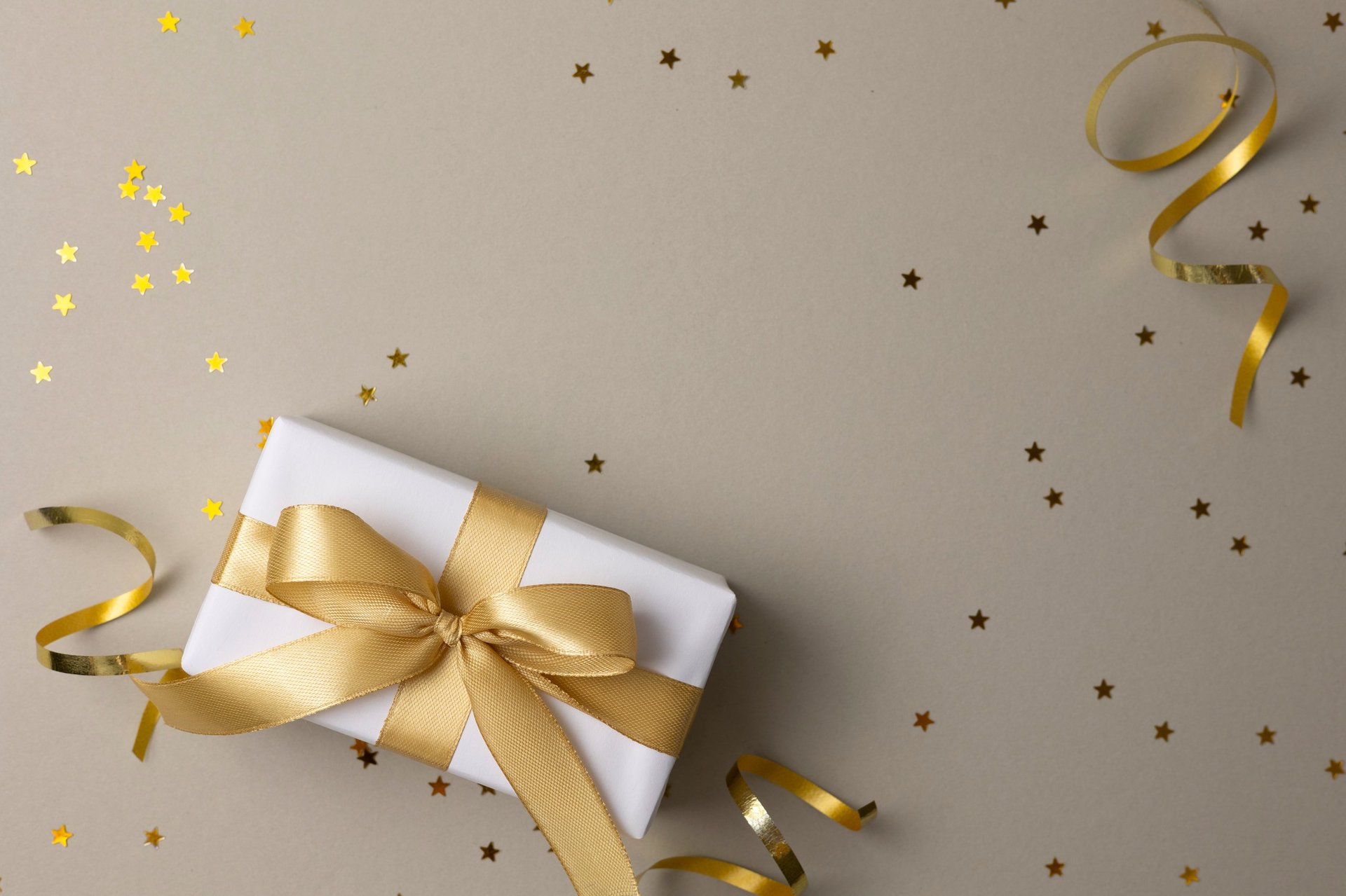 Flat lay of elegant gift boxes with golden ribbons, luxury gifting presentation