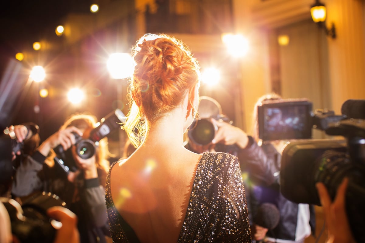 Red carpet paparazzi camera flashes