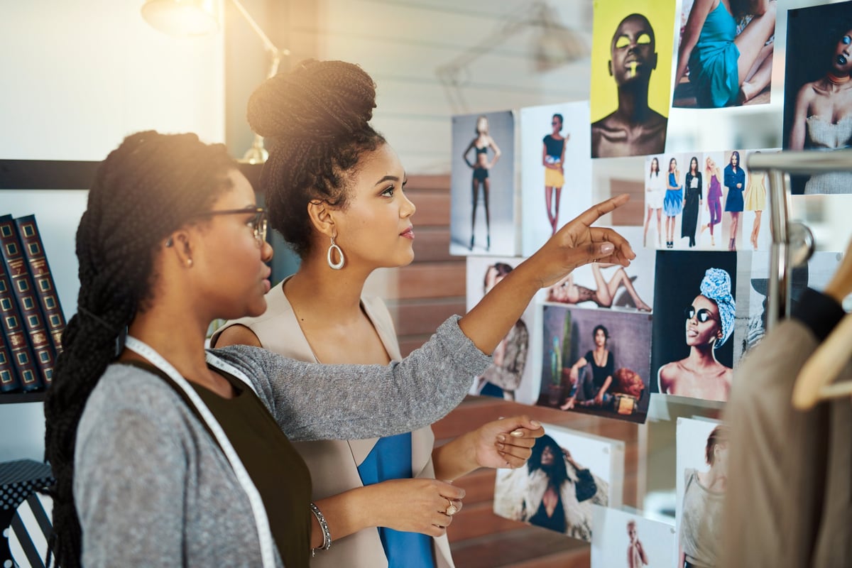 Two fashion designers collaborating on a new design