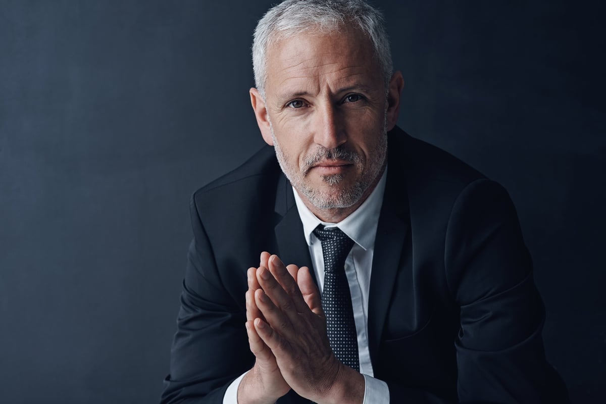 Studio portrait of a mature businessman against a dark background
