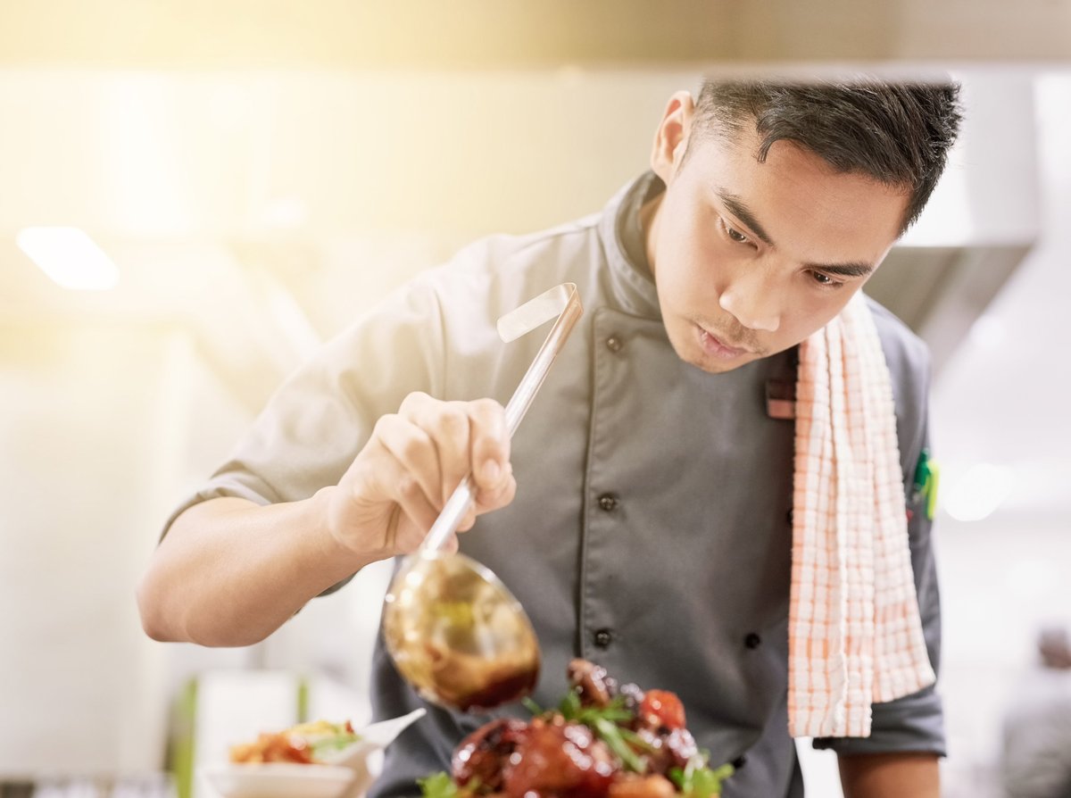 Young male chef cooking