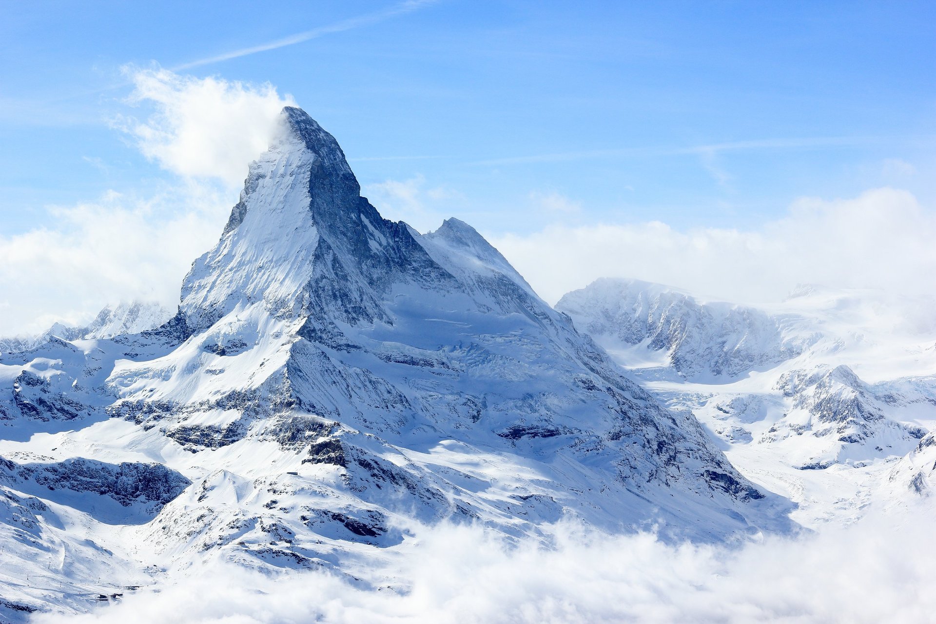 The Unterrothorn mountain of the Swiss Pennine Alps, overlooking Zermatt with snow-capped peaks under sunlight
