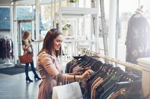 Shot of a young woman shopping at a clothing store