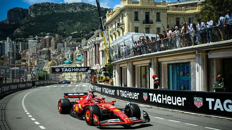 Red Formula 1 race car navigating a tight corner on a street circuit with buildings and spectators lining the track
