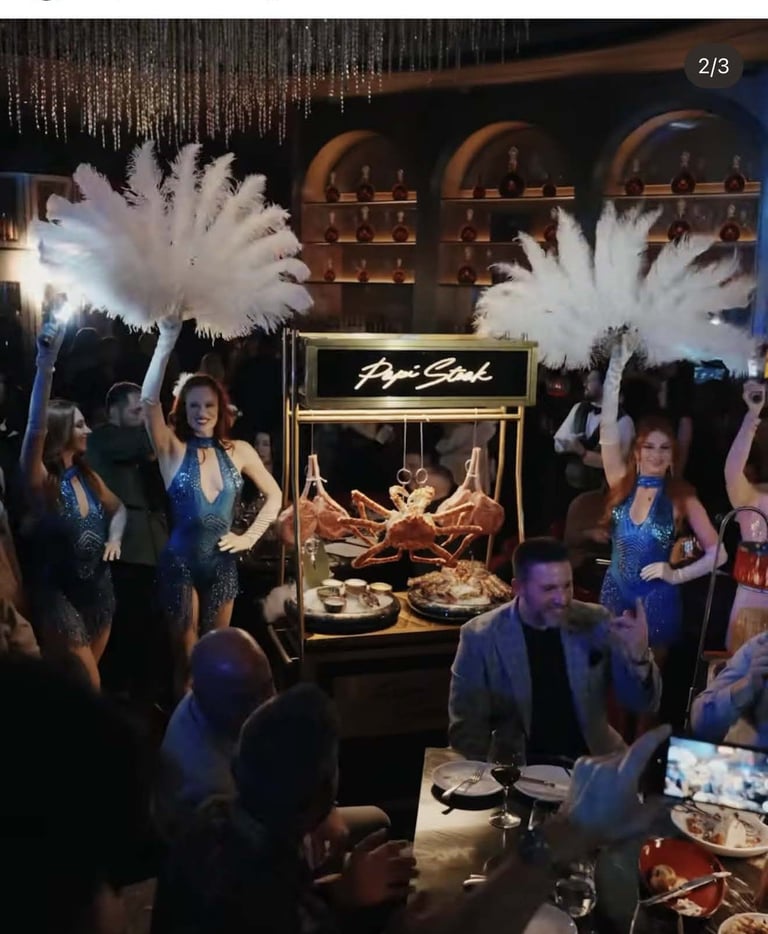 Upscale restaurant event with elegantly dressed guests, white feathered decorations, and a seafood display with lobsters and shellfish