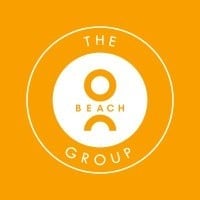 The Beach Group logo featuring a circle design with a simple beach-themed icon on orange background