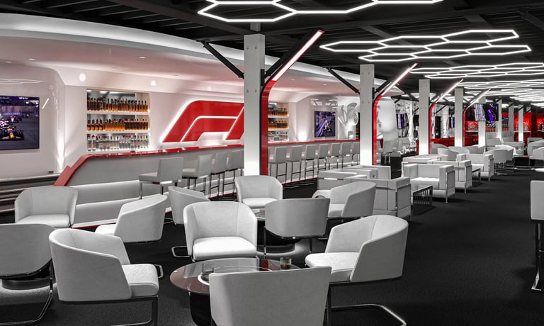 Modern Formula 1 lounge with white and gray seating, red F1 logo, bar area, and hexagonal ceiling lights
