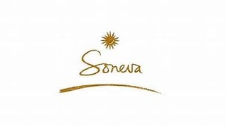 Soneva logo featuring a sun symbol and stylized script text with a curved line