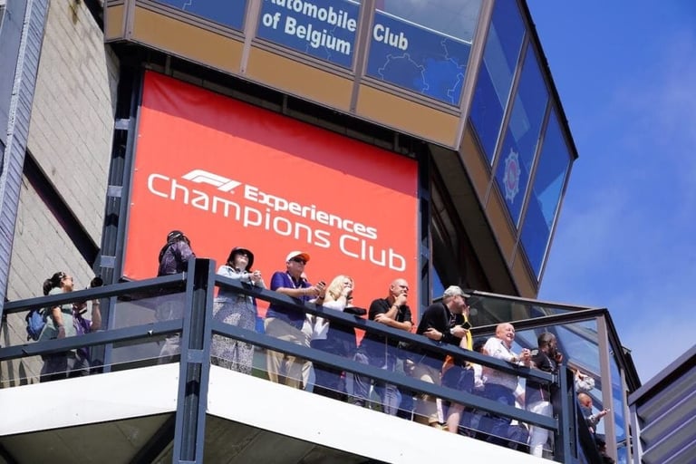 F1 Experiences Champions Club signage with spectators on a viewing platform at a racing venue