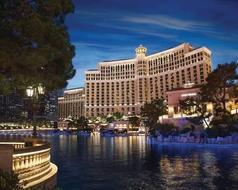 Bellagio Hotel and Casino illuminated at dusk with fountains and reflecting pool in Las Vegas